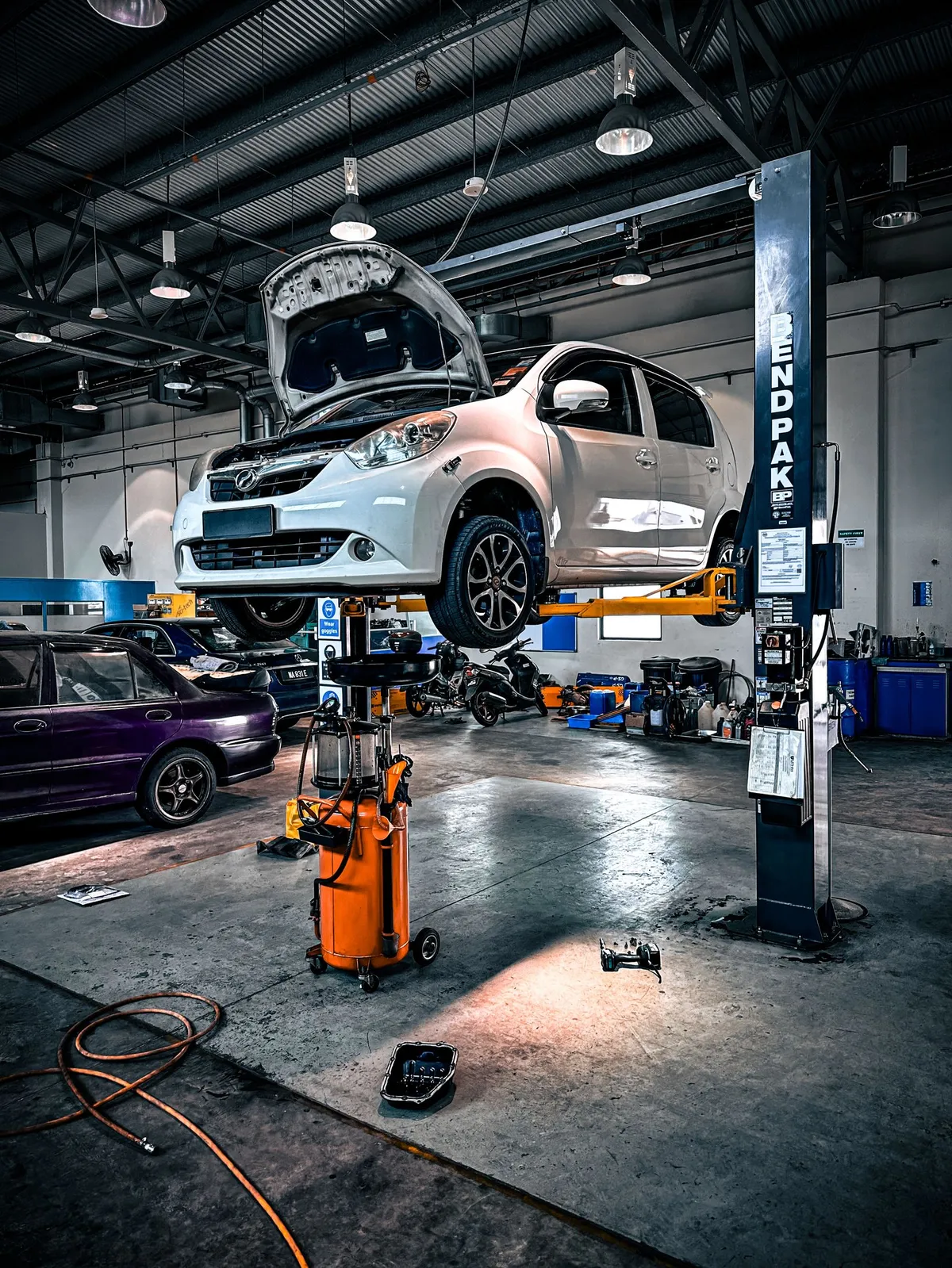 Car raised on a lift for structural work
