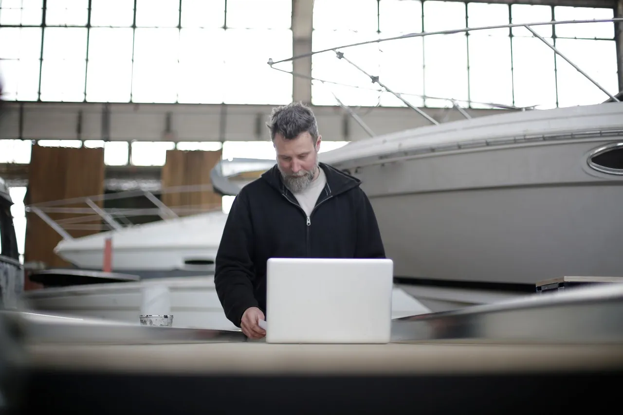 Technician with a motorboat in the service hangar