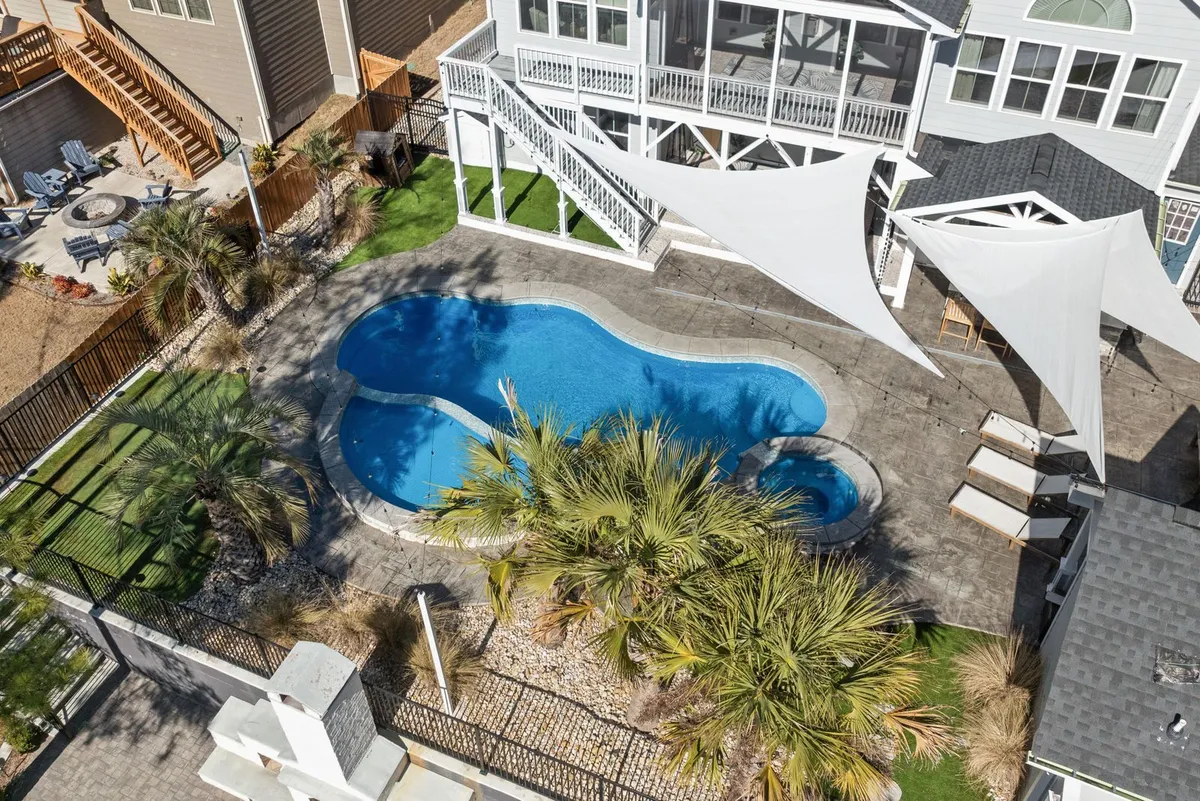 Aerial view of a freeform kidney-shaped backyard pool