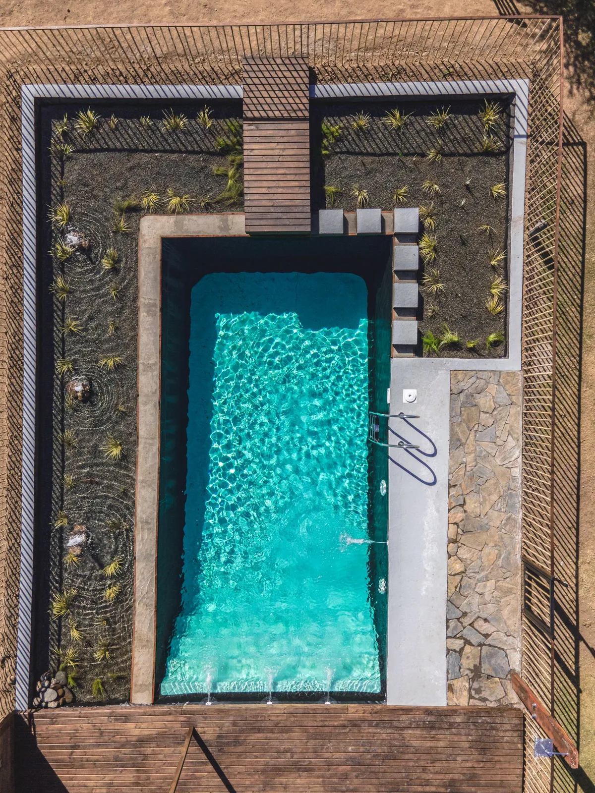 Aerial view of a geometric rectangular pool with landscaped surround